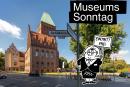 Cartoon-Figur mit einem Schild mit der Aufschrift "Eintritt frei" vor dem Märkischen Museum